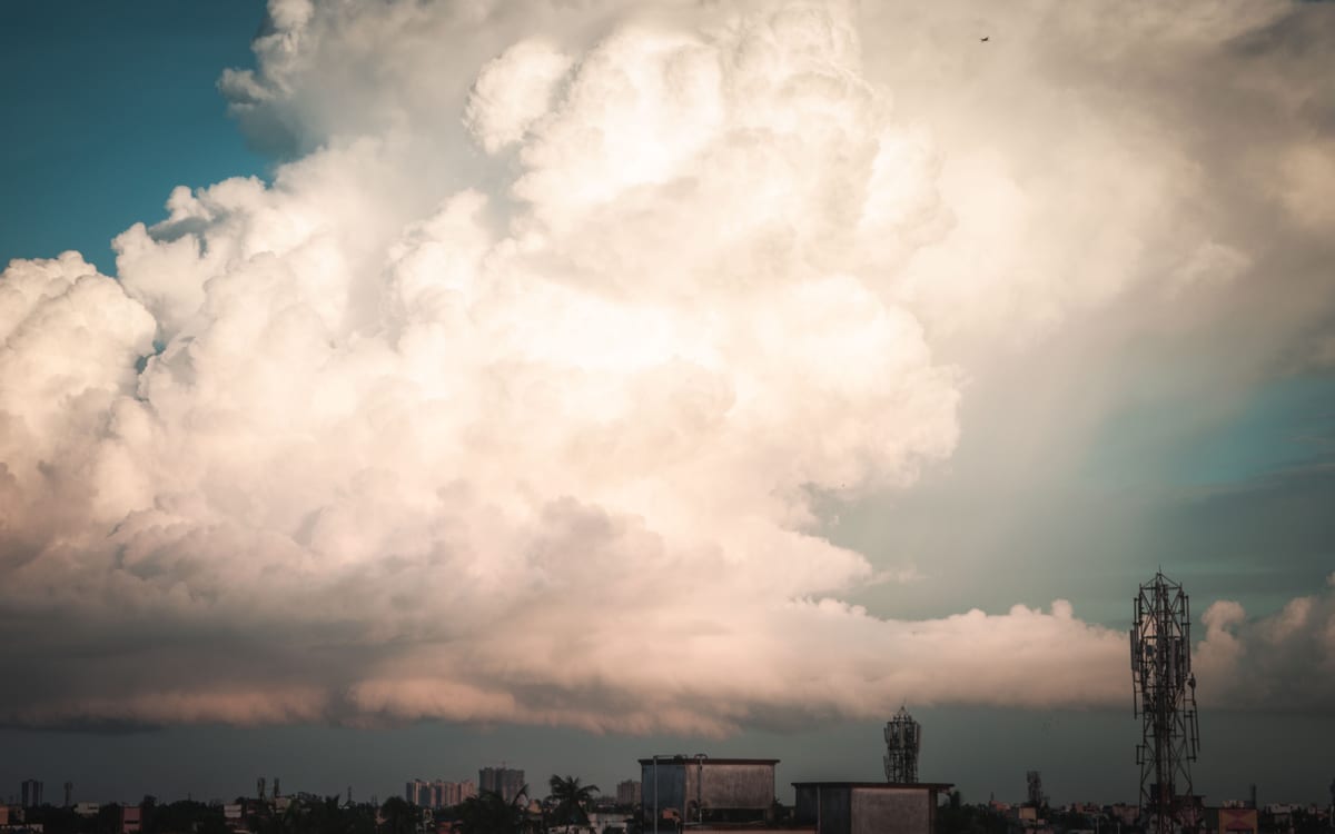 Stunning cumulus clouds towering over the urban skyline of Kolkata, creating a dramatic scene.