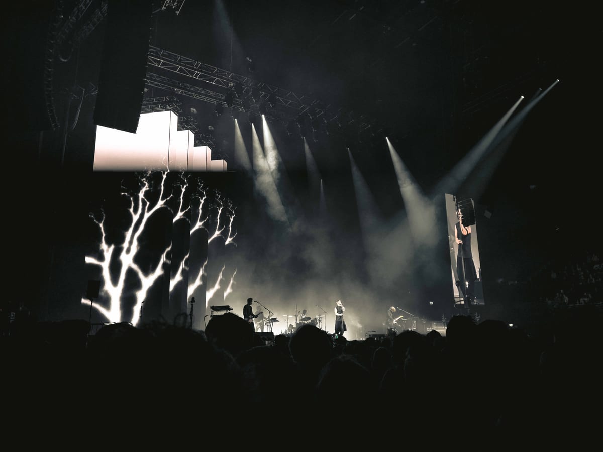 Engaging night concert with lights, smoke, and audience in Amsterdam.