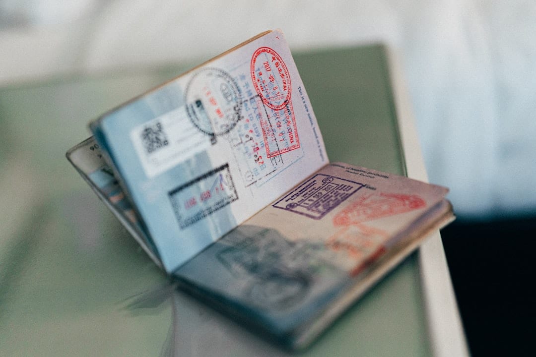 An open passport with multiple colorful ink stamps on the pages