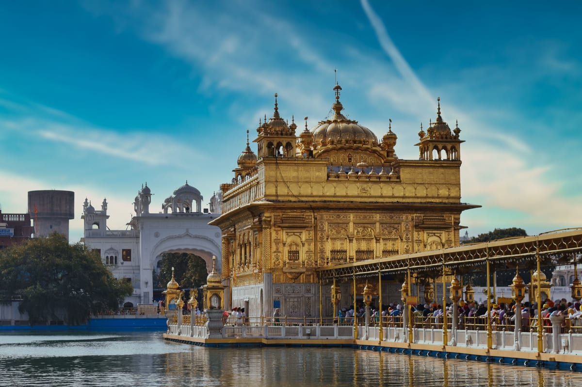 Stunning view of the Golden Temple in Amritsar, India, gleaming under the bright sky.