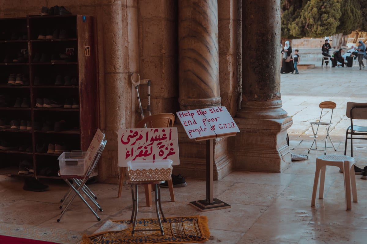 Signs for charity seeking help for Gaza at a historical site in Jerusalem.