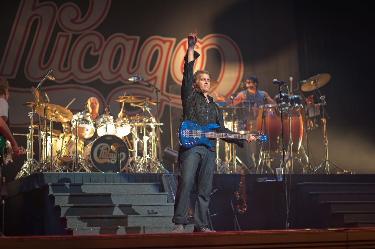 Energetic live concert show featuring musicians performing with drums, guitar, and bass.