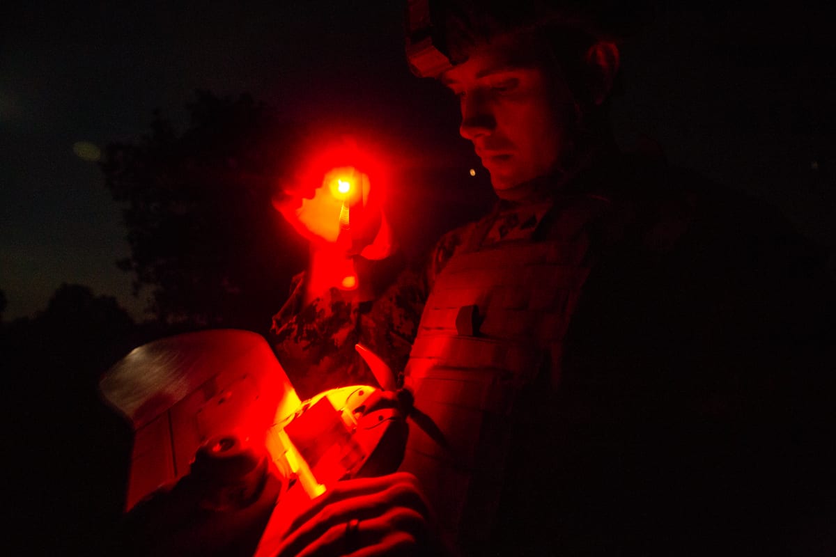 A U.S. Marine with Black Sea Rotational Force 18.1 conducts a post-flight analysis on drone-acquired intelligence while maintaining light discipline for live fire ranges during Exercise Platinum Lion