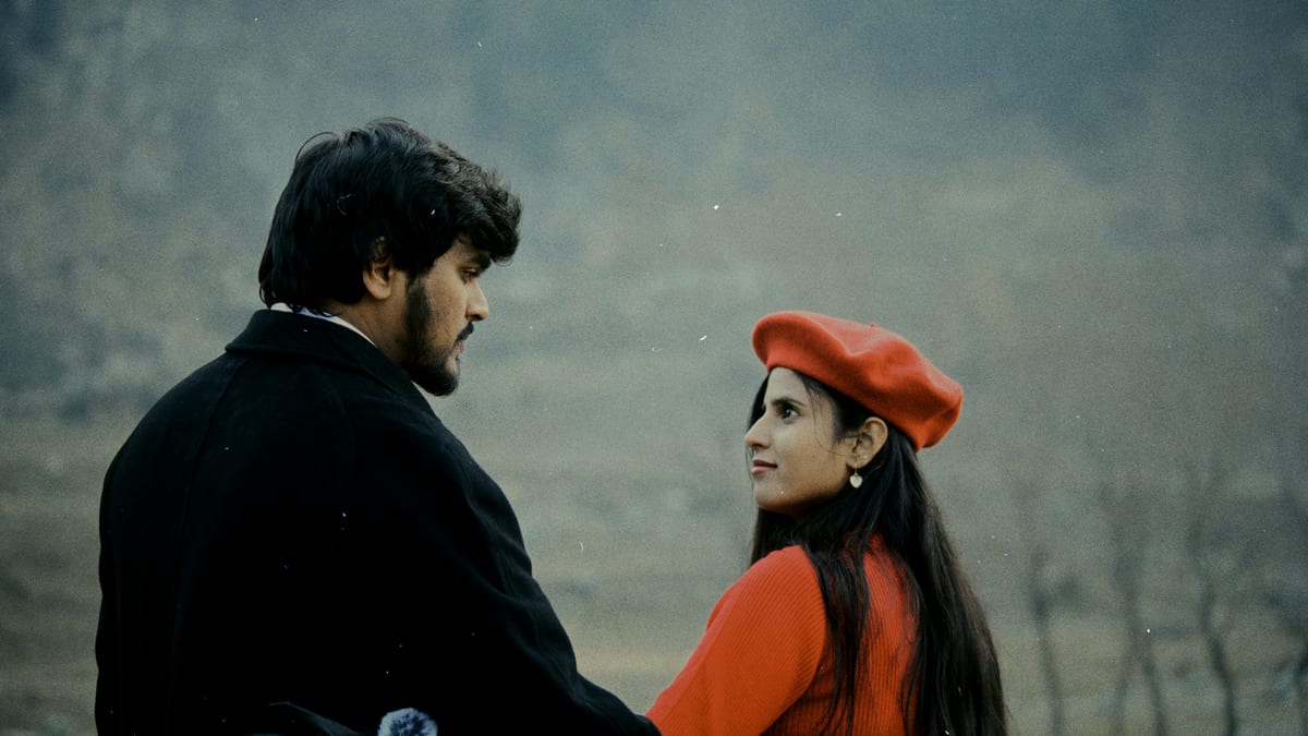 A couple enjoying a romantic moment in a misty autumn field, dressed elegantly.