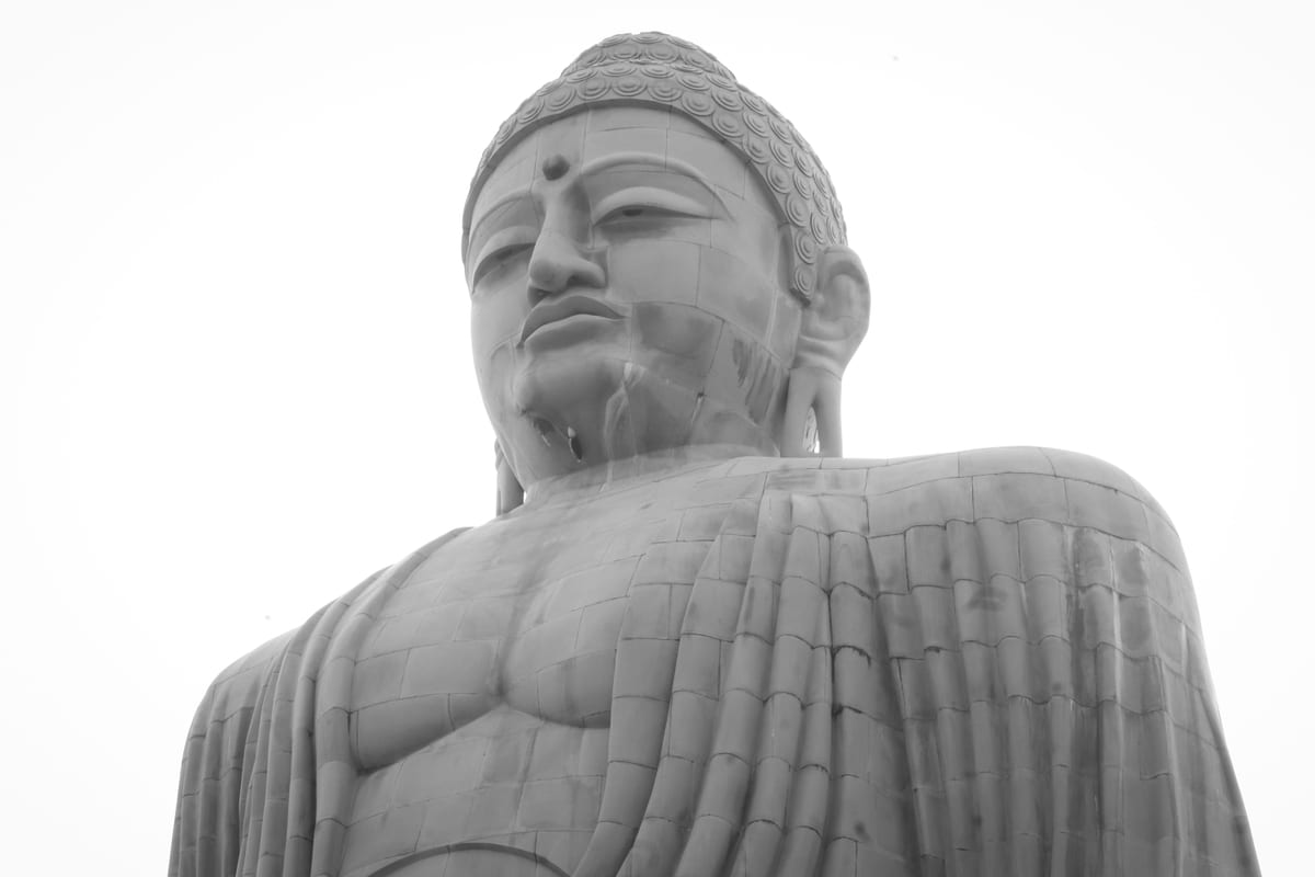 Striking black and white image of the giant Buddha statue in Bodh Gaya, symbolic of peace and spirituality.