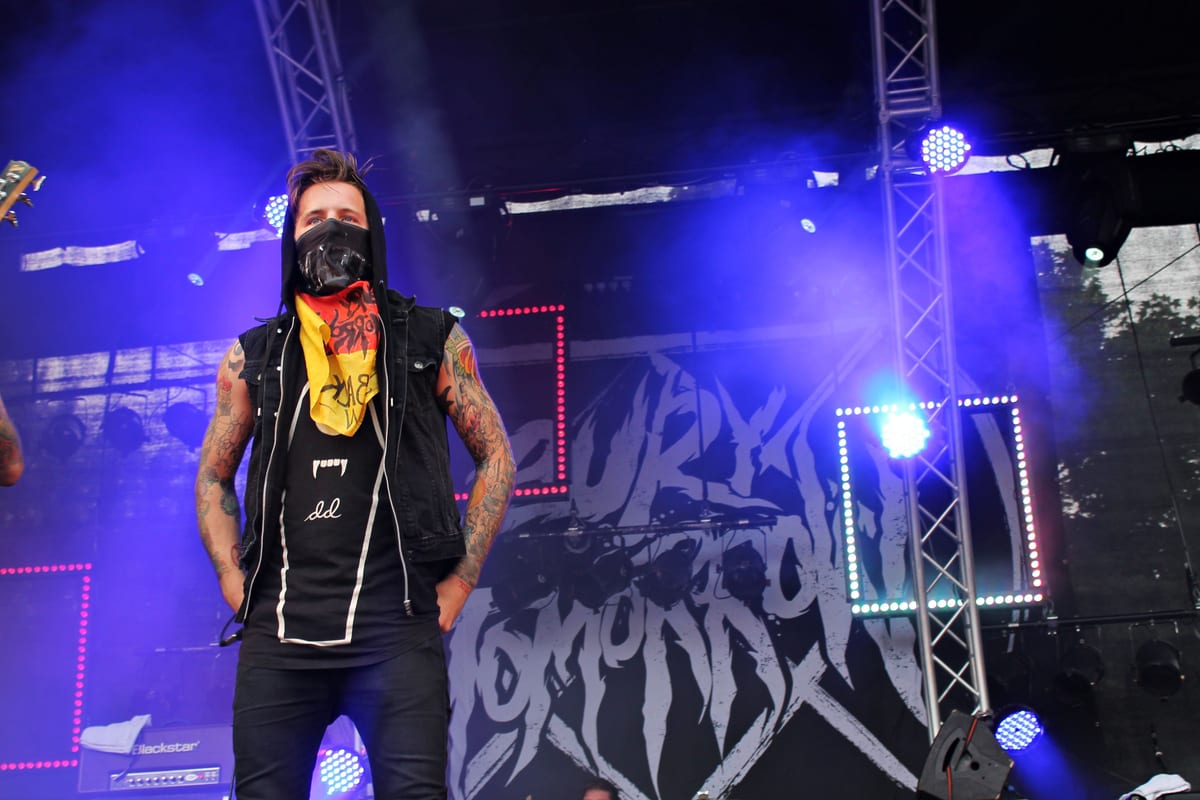 Vibrant stage performance by a metal band, featuring energetic lights and powerful presence.