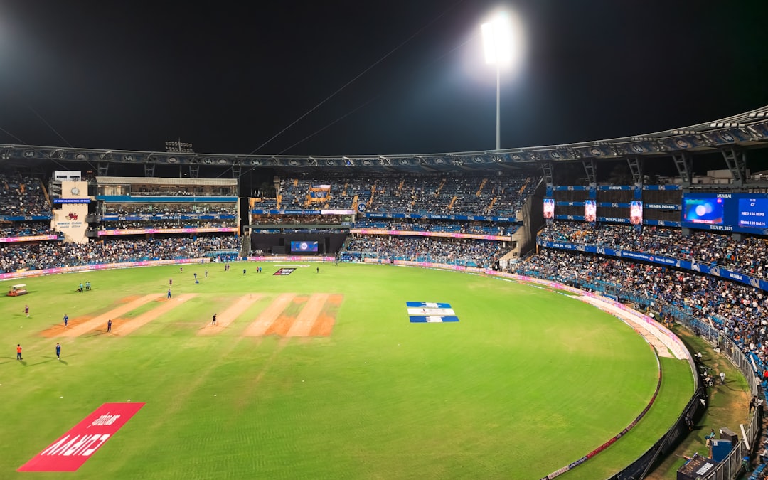 A cricket match is being played at a stadium.
