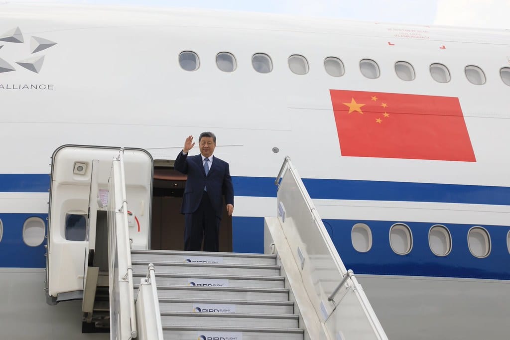 President Xi Jinping waves from the aircraft door on arrival in New Delhi for the 18th BRICS Summit