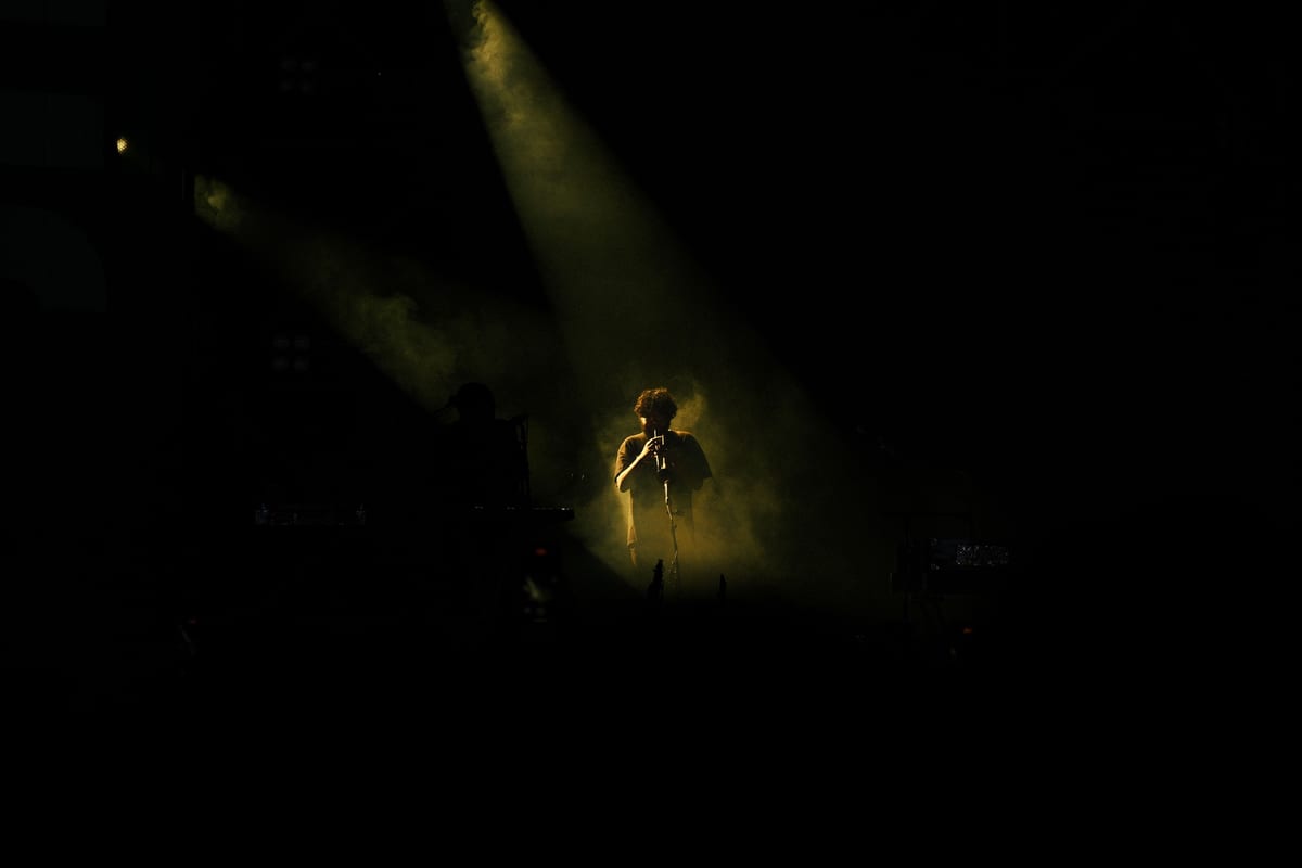 Captivating concert scene featuring a flute player under dramatic stage lighting.