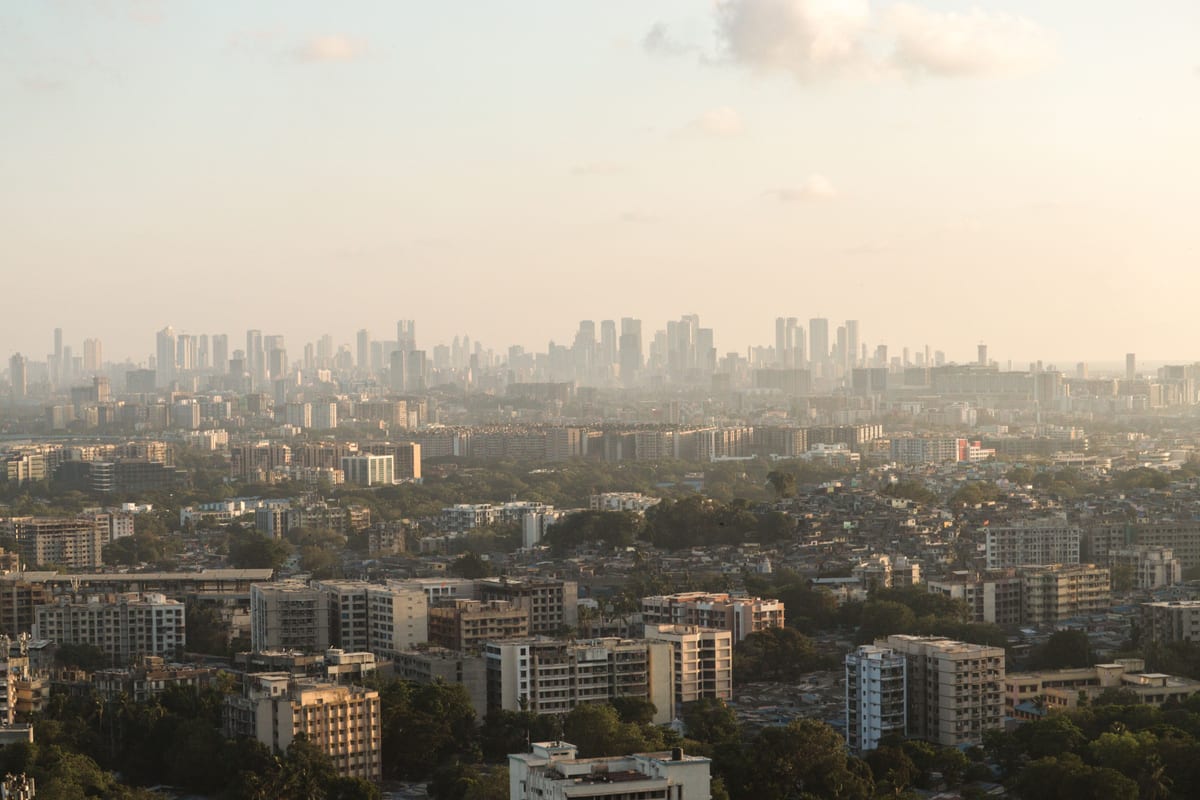 Stunning aerial view of Mumbai's skyline with urban landscape at sunrise.