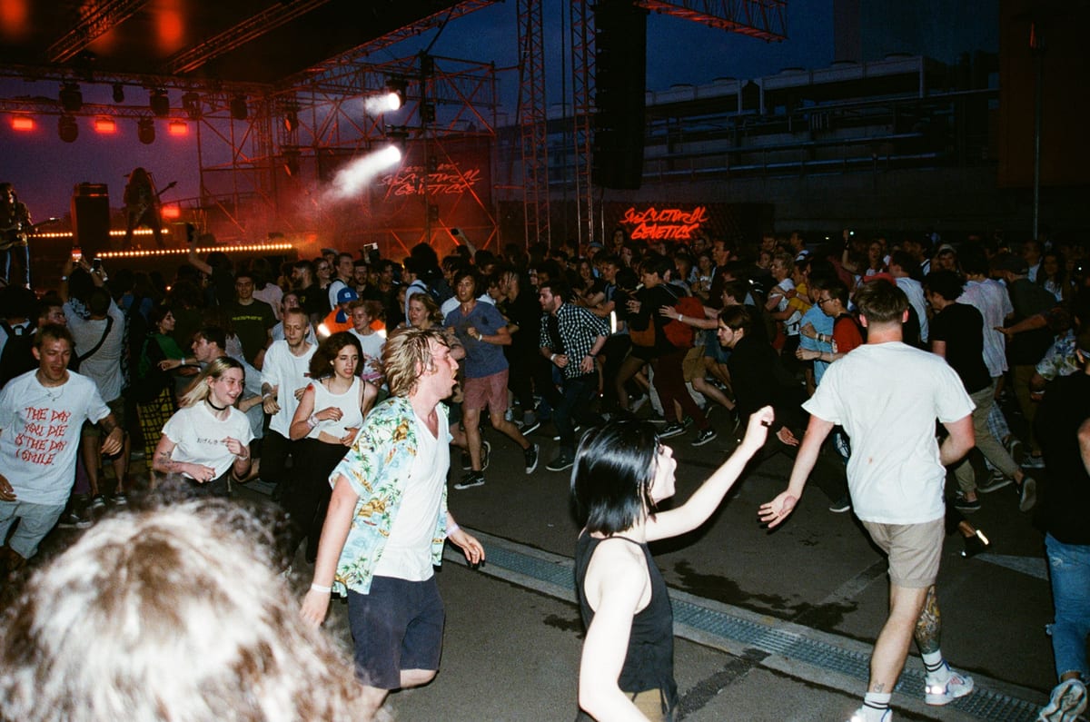 A lively concert crowd in a mosh pit during a music festival in Moscow, Russia.