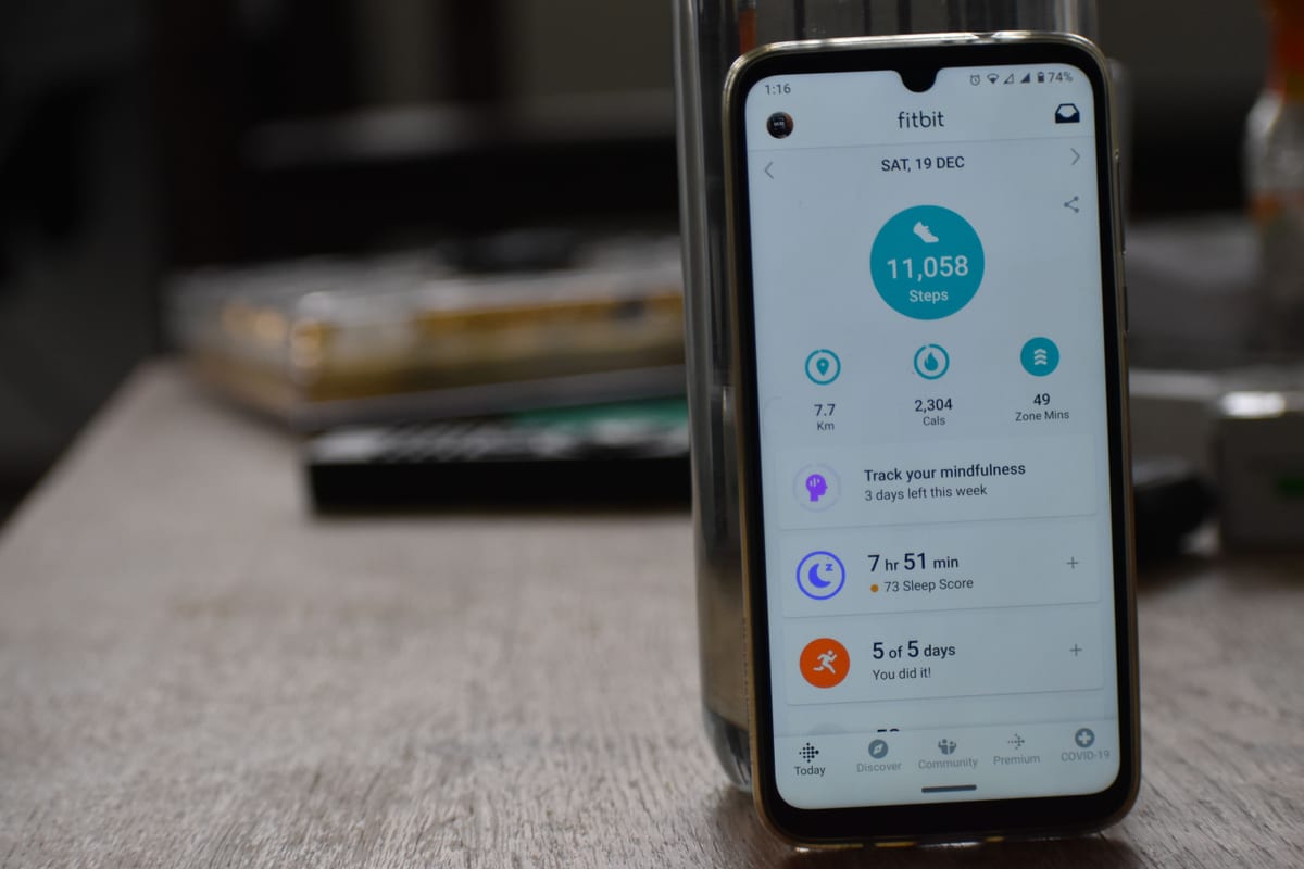 Close-up of a smartphone displaying a fitness tracking app with health statistics.