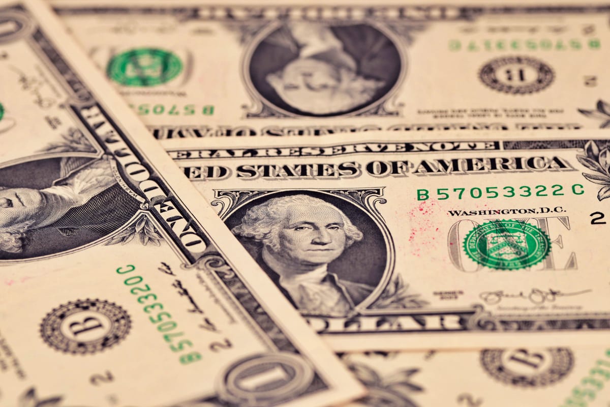 Detailed close-up of US one dollar bills showcasing intricate design and texture.