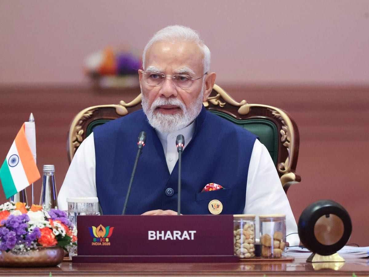 Prime Minister Narendra Modi seated behind the BHARAT placard at the 18th BRICS Summit plenary, Bharat Mandapam, New Delhi