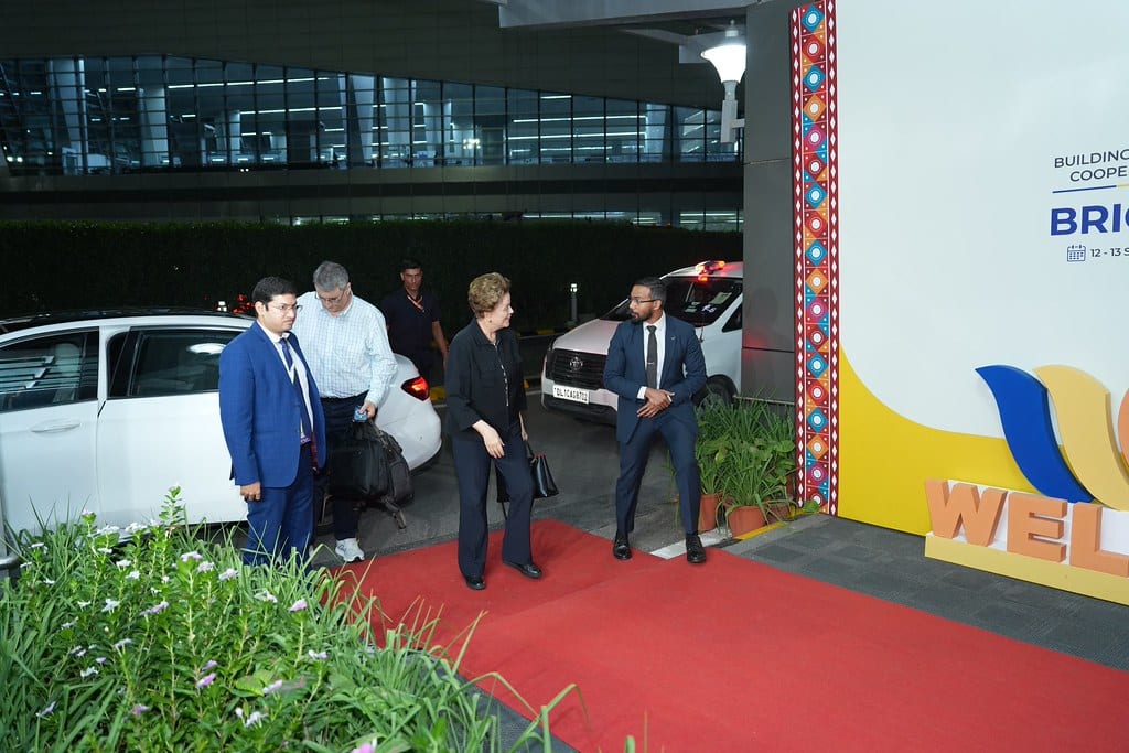 Dilma Rousseff, President of the New Development Bank, on the red carpet at New Delhi airport beneath the BRICS Summit welcome signage