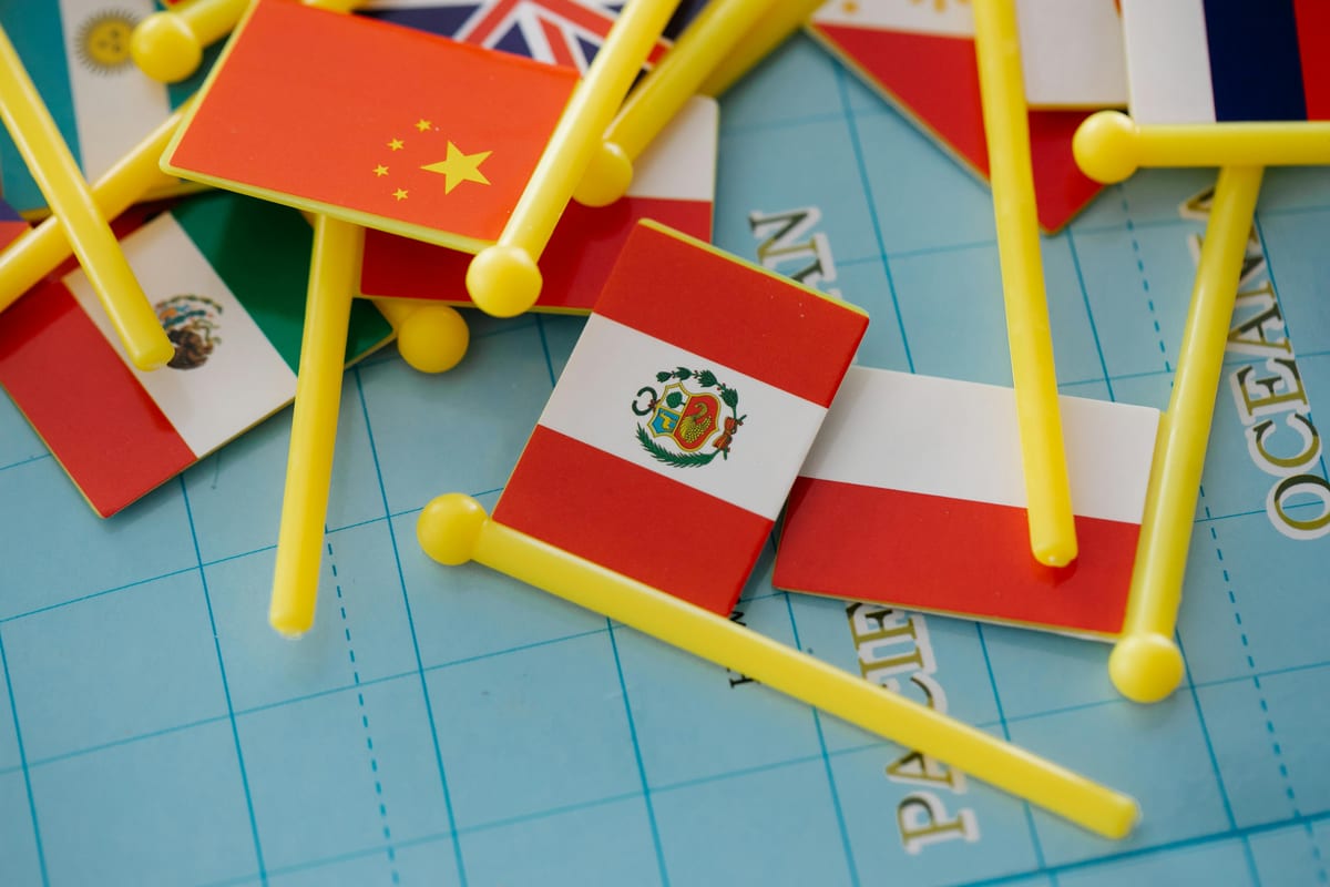 Collection of miniature flags on a world map representing global diversity.