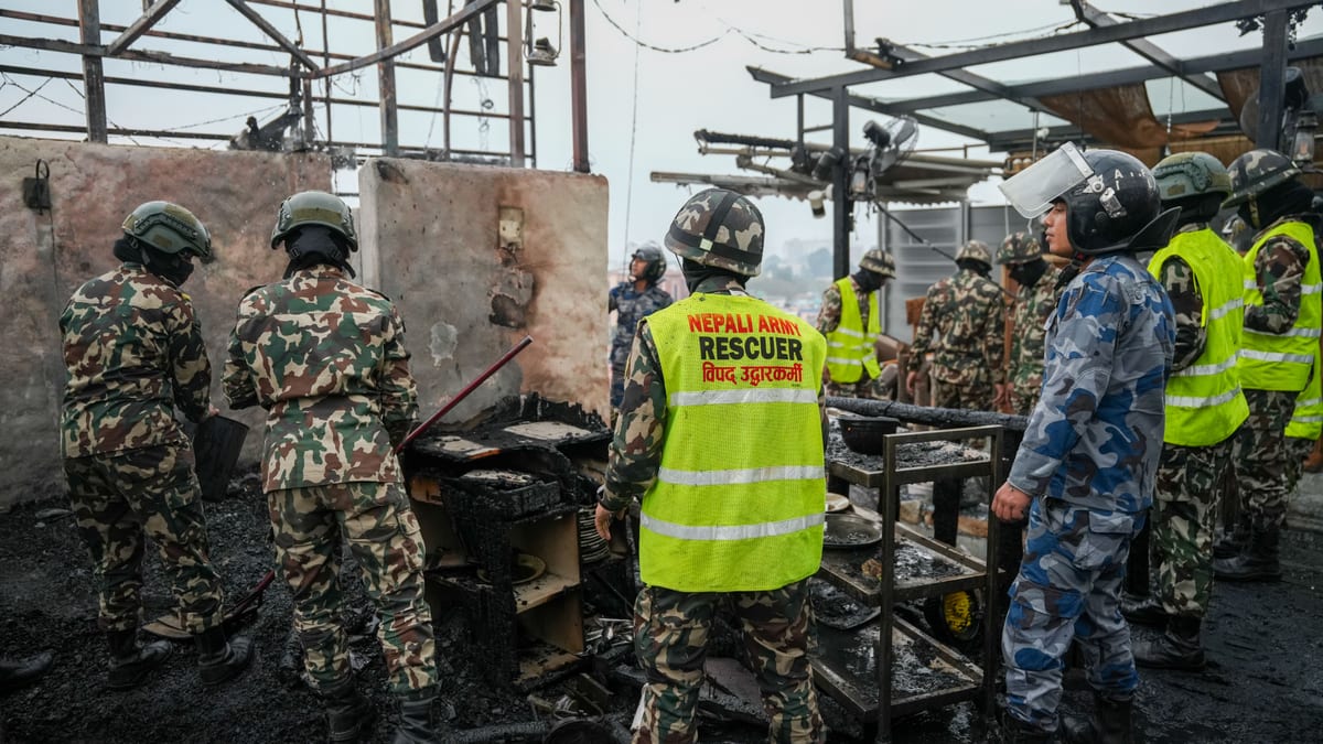 Nepali Army rescuers in action at a disaster site, collaborating amidst damaged infrastructure.
