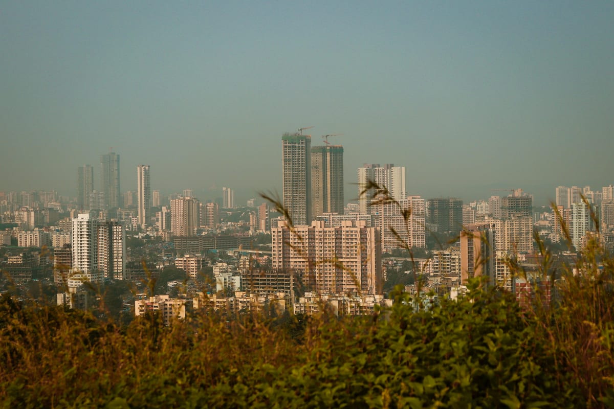 Explore the bustling urban skyline with high-rise buildings under a clear sky, showcasing modern city life.