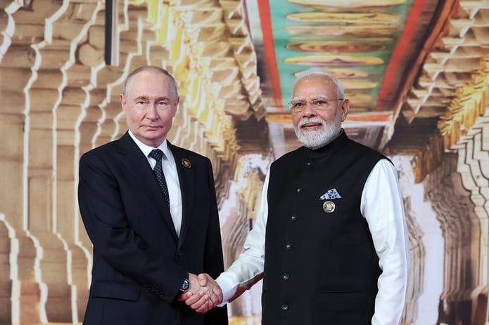 Prime Minister Narendra Modi shakes hands with President Vladimir Putin at the leaders' welcome, 18th BRICS Summit, Bharat Mandapam, New Delhi