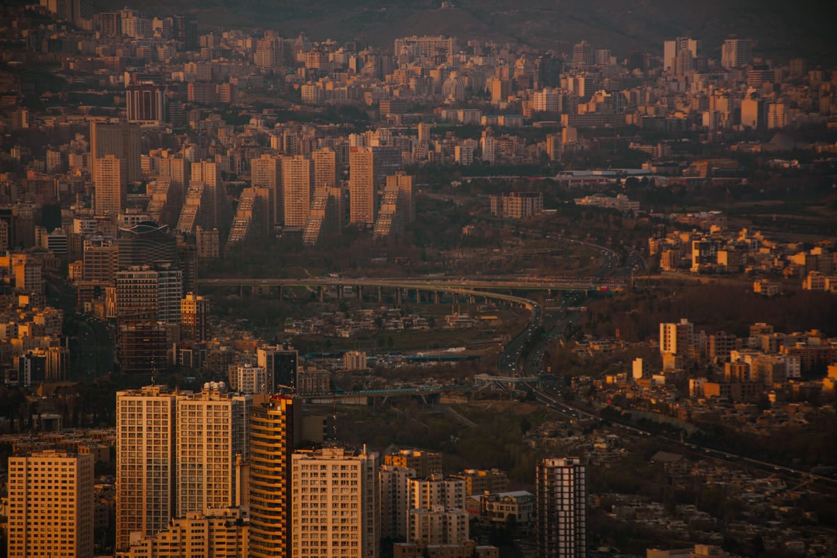 Stunning panoramic view of Tehran's skyline at dusk, showcasing the city's dense urban environment and architectural diversity.