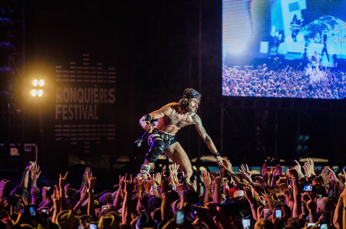 Dynamic live performance at Ronquières Festival capturing the energy of the crowd and musician.