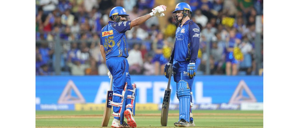 Two Mumbai Indians batsmen fist-bump during a partnership in TATA IPL 2026