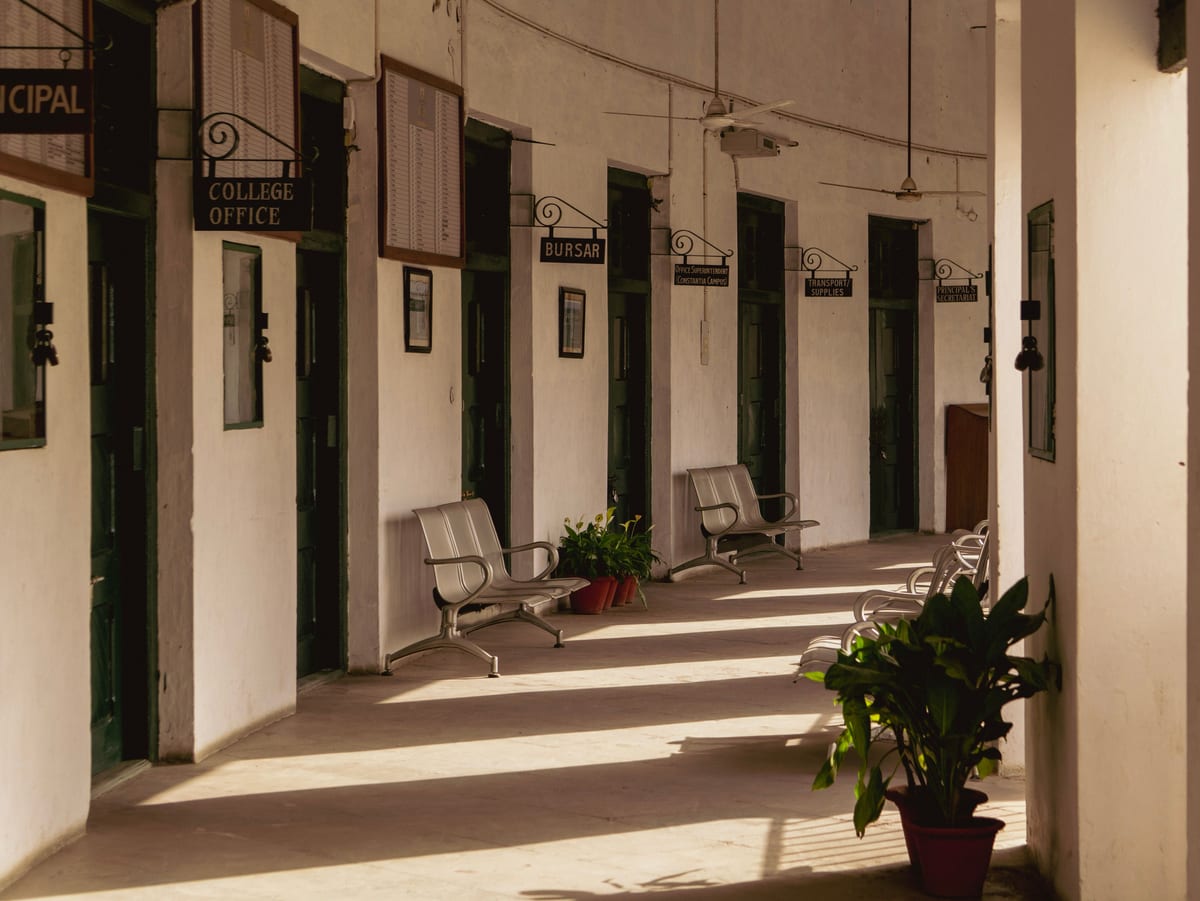 Serene corridor of La Martiniere College in Lucknow, India, showcasing vintage architecture.