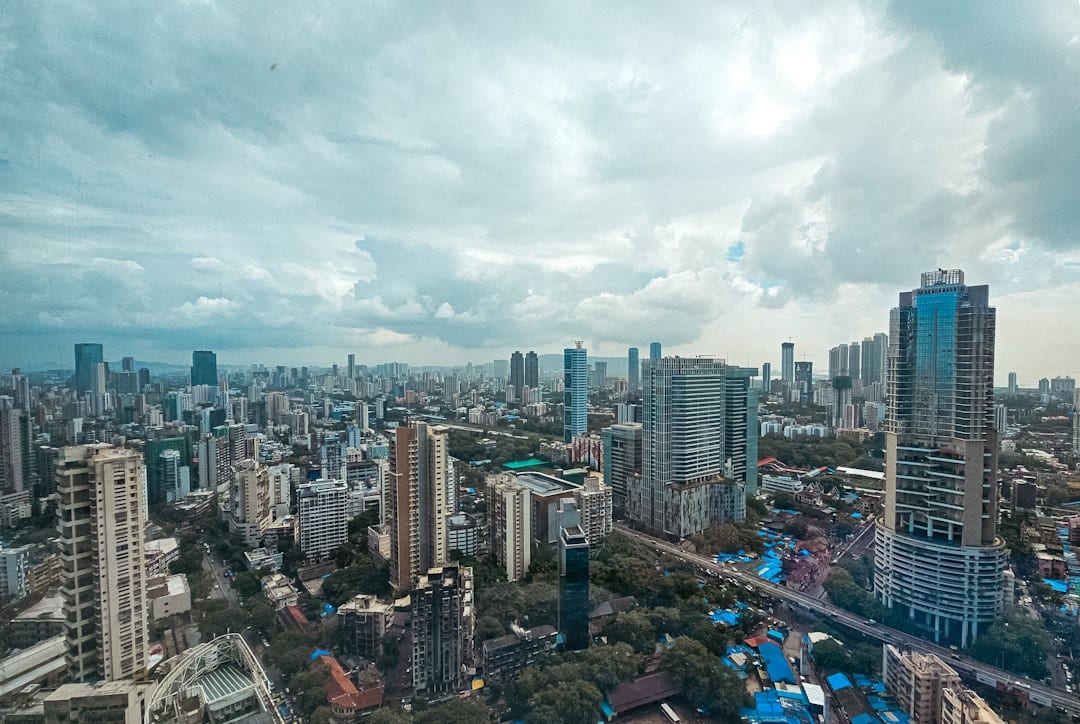 Panoramic view of a dense cityscape under cloudy skies