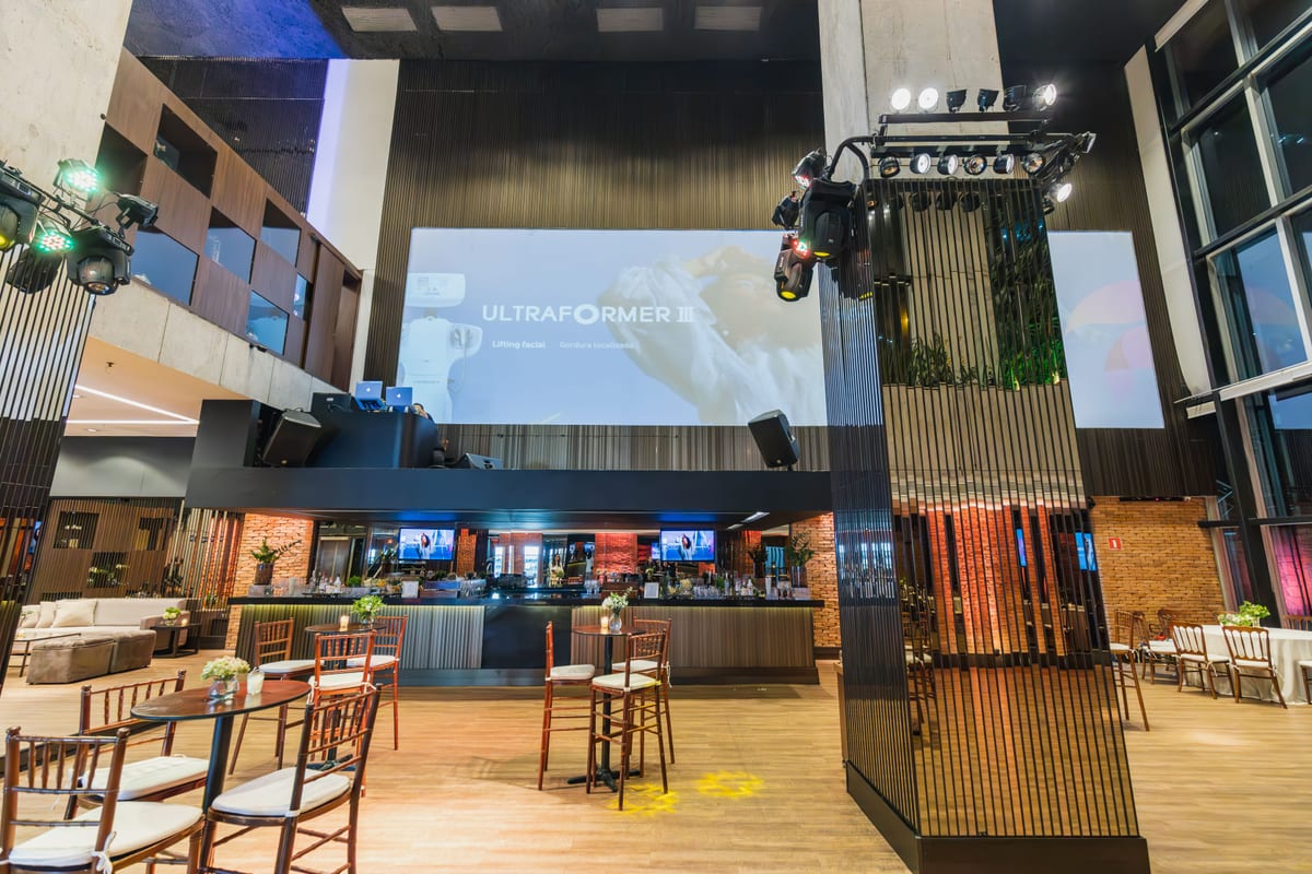 Spacious and modern event hall with projection screen setup, perfect for celebrations and conferences.
