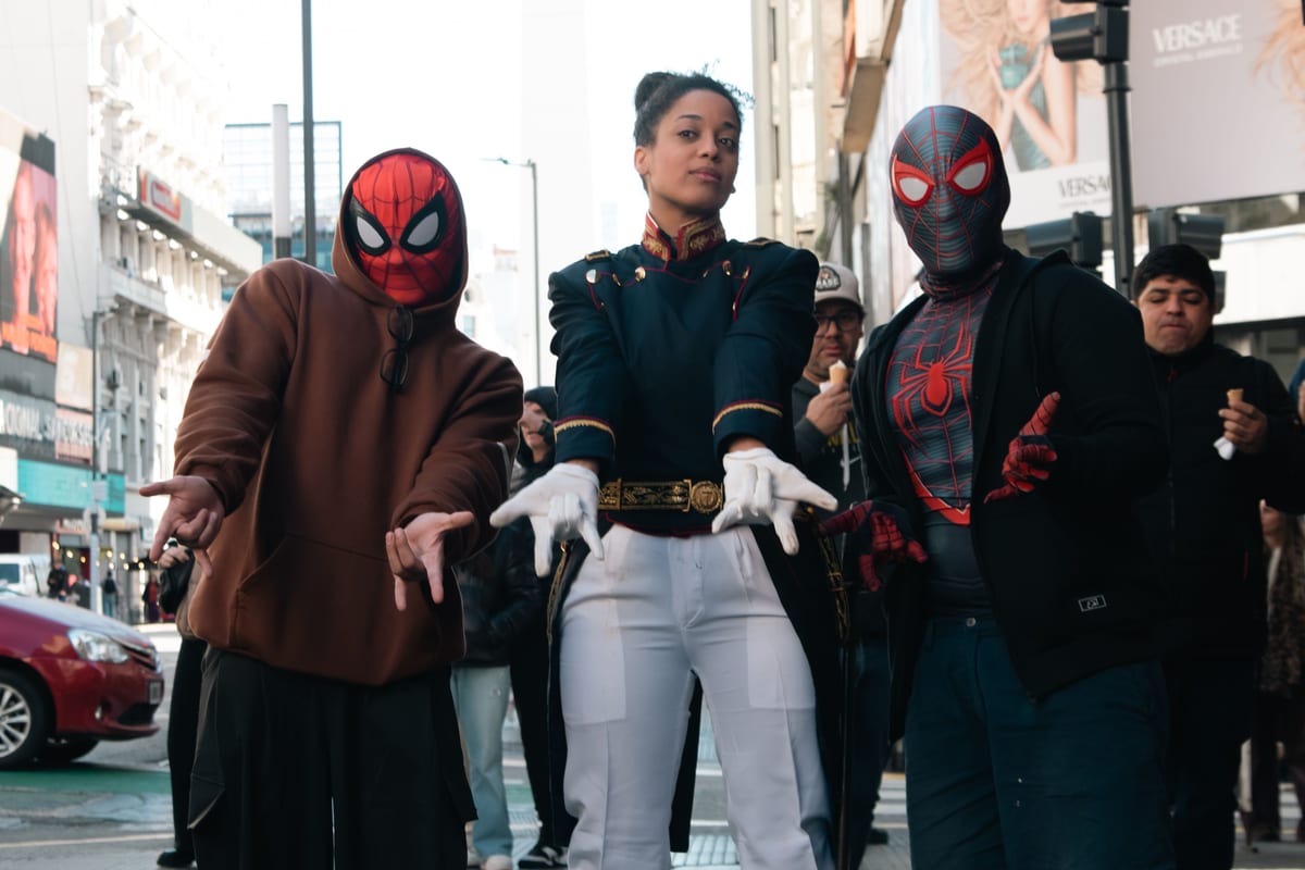 Three people in cosplay pose on a bustling city street. Captivating urban scene with vibrant costumes.