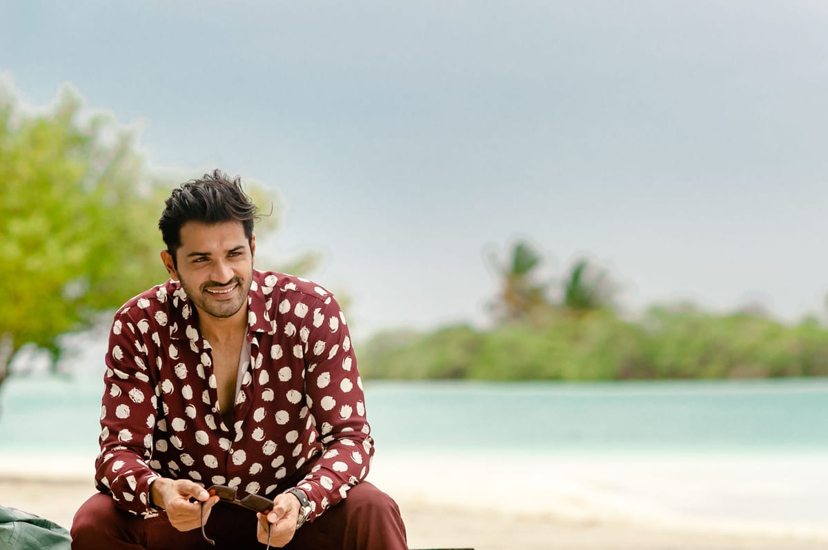 Fashionable man enjoying a sunny day on the beach in Maldives.