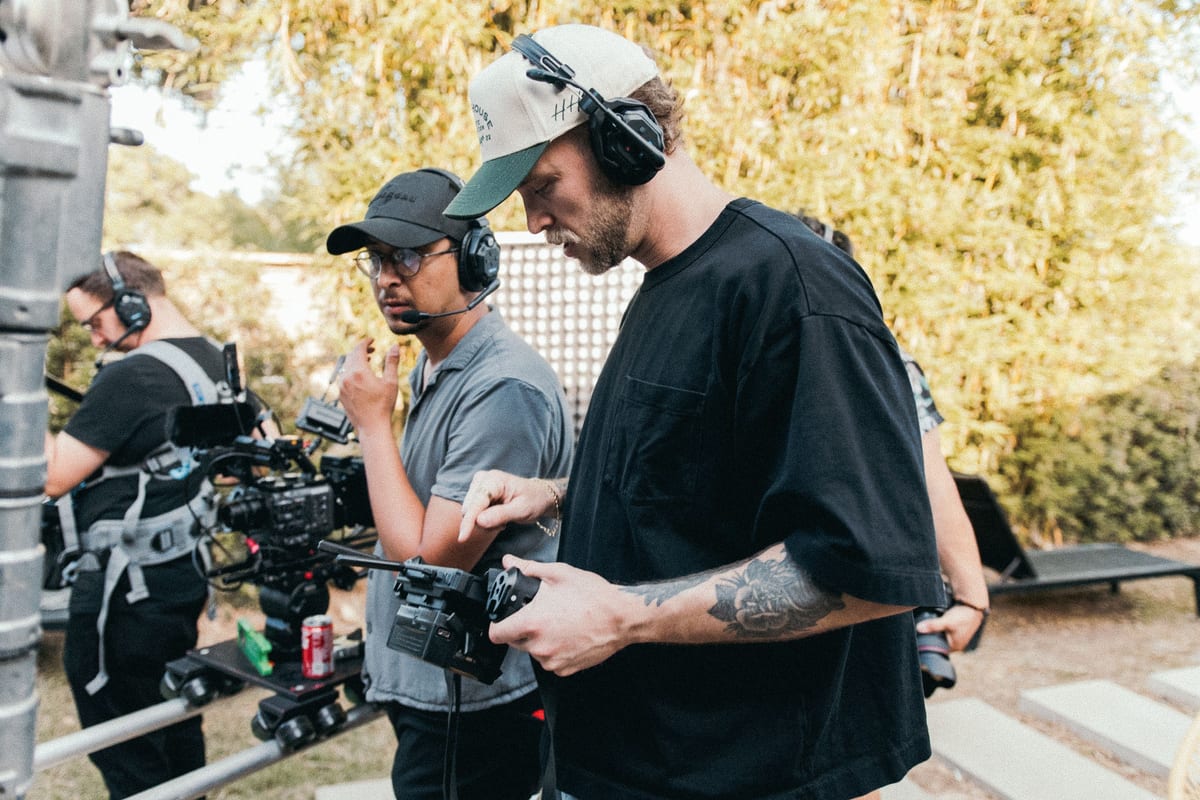 Filmmakers and camera crew working on set, capturing creative moments outdoors.